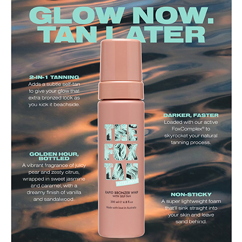 A pink bottle of The Fox Tan Rapid Bronzer Whip with self-tan stands against a textured background; visible text includes phrases about the products benefits, such as GLOW NOW. TAN LATER, 2-IN-1 TANNING, DARKER, FASTER, GOLDEN HOUR, BOTTLED, and NON-STICKY.