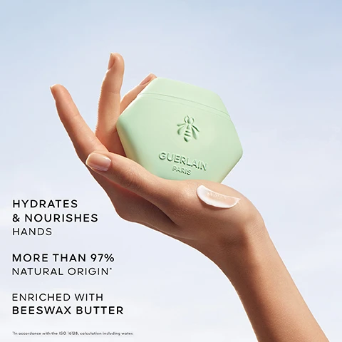 Image 1 - A hand holds a light green hexagonal container of Guerlain hand cream against a clear blue sky, with visible text stating HYDRATES & NOURISHES HANDS, MORE THAN 97% NATURAL ORIGIN, and ENRICHED WITH BEESWAX BUTTER.
              Image 2 - An overhead view of pink rose petals and cucumber slices floating in water with droplets, featuring the text ROSE, CUCUMBER, MINT.
              Image 3 - A green hexagonal container labeled Guerlain Paris is shown next to a bottle of Aqua Allegoria Rosa Verde, which features a gold honeycomb cap, all against a bright backdrop with the text ROSA VERDE SCENTED RITUAL in the upper left corner.