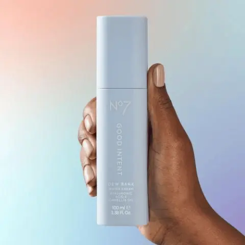 Image - A light blue bottle of No7 Good Intent Dew Bank Water Cream, containing Hyaluronic Acid & Camellia Oil, 100 ml e, 3.38 Fl. Oz., stands on a textured surface against a light blue background, with the prominent text Dew Bank Water Cream above, and three descriptive points beside it: Drench and quench with this lightweight water cream; Delivers an instant hit of hydration to dull, dry skin; Rehydrating formula leaves skin dewy and silky-soft.