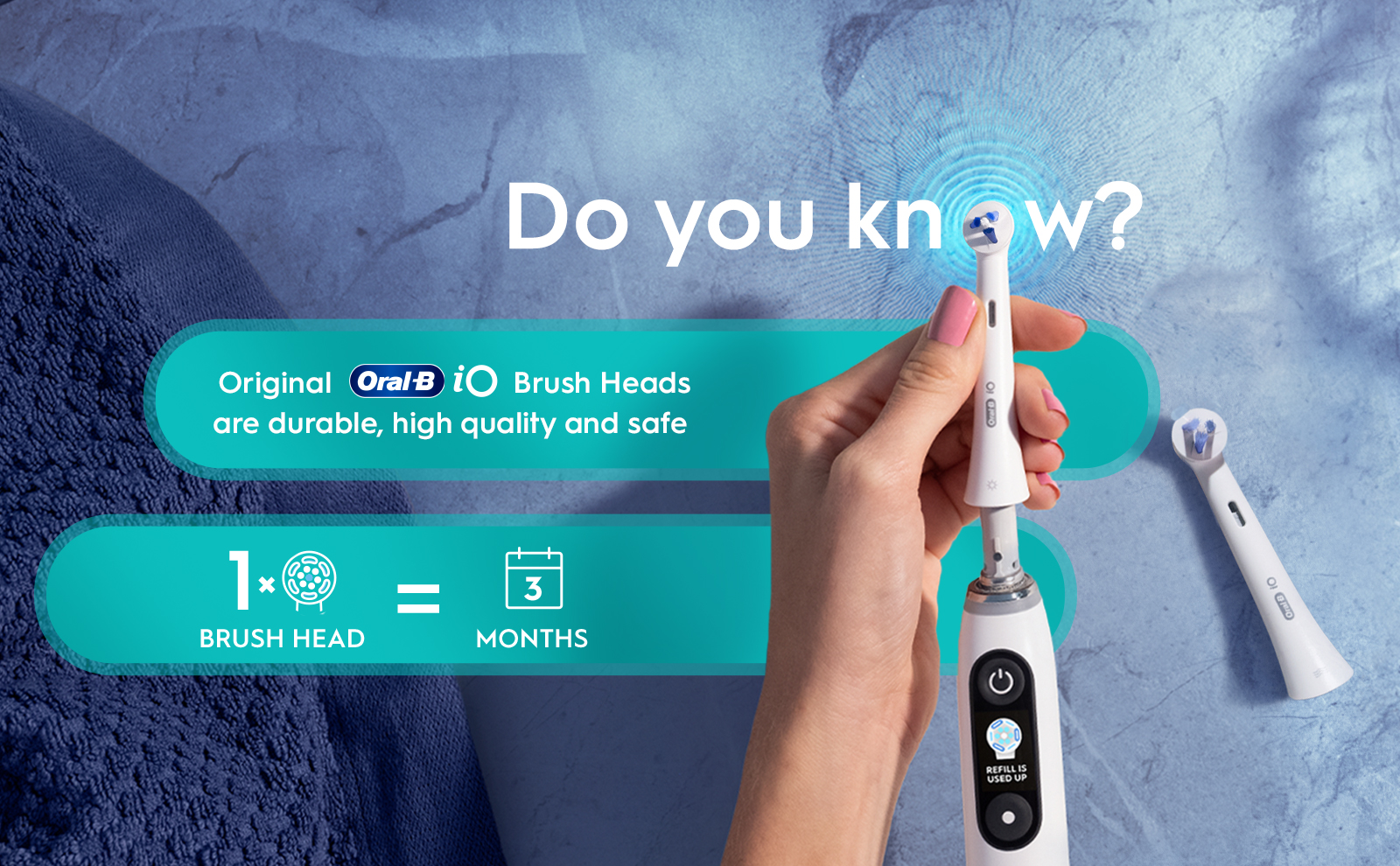 Hand holds Oral-B iO brush head that lasts for 3 months, making it less than 4 € a month.