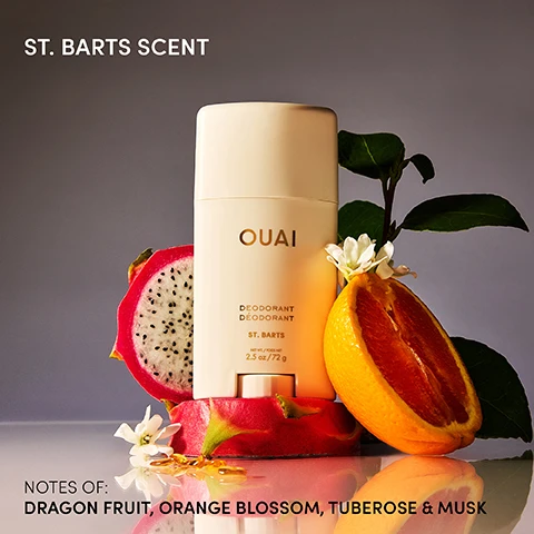 Image 1 - A cream-colored OUAI deodorant stick stands between a halved dragon fruit and a halved orange with white flowers and green leaves, displaying the text ST. BARTS SCENT, OUAI DEODORANT DÉODORANT ST. BARTS NET WT./POIDS NET 2.5 oz/72 g, and NOTES OF: DRAGON FRUIT, ORANGE BLOSSOM, TUBEROSE & MUSK. Image 2 - A woman with braided hair wearing a yellow bikini top holds a white deodorant stick above her head, with text reading New St. Barts Deodorant, Ouai Deodorant St. Barts 2.5 oz / 72 g, Goes on Clear, Aluminum-Free, and Smell Like Youre on Ouai-cation for 24 Hours. Image 3 - Three light beige deodorant sticks, two upright and one on its side, display text including OUAI, DEODORANT DÉODORANT, ST. BARTS, and 2.5 oz / 72 g, with icons below indicating ALUMINUM-FREE, BAKING SODA-FREE, CRUELTY-FREE, RECYCLABLE, and SUSTAINABLE. Image 4 - A person with braided hair and dark skin wearing a bright yellow sports bra and leggings with arms raised above their head, with text SWIPE YOUR SCENT NEW ST. BARTS DEODORANT ONE SWIPE & YOURE ON OUAI-CATION. Image 5 - A woman with dark skin and braided hair, wearing a yellow top, applies Ouai Deodorant St. Barts to her raised underarm, while the prominent text Goes On Clear is displayed at the top of the image. Image 6 - A light beige Ouai deodorant stick with its cap off is displayed on a textured surface, with visible text on the product reading OUAI DEODORANT DÉODORANT ST. BARTS NET WT. / POIDS NET 2.5 oz / 72 g, and additional text explaining ingredients: Tapioca Starch helps absorb moisture, Piroctone Olamine neutralizes body odor & helps you stay fresh, Shea Butter hydrates, leaves skin looking soft & smooth, Coconut Oil moisturizes & nourishes skin.