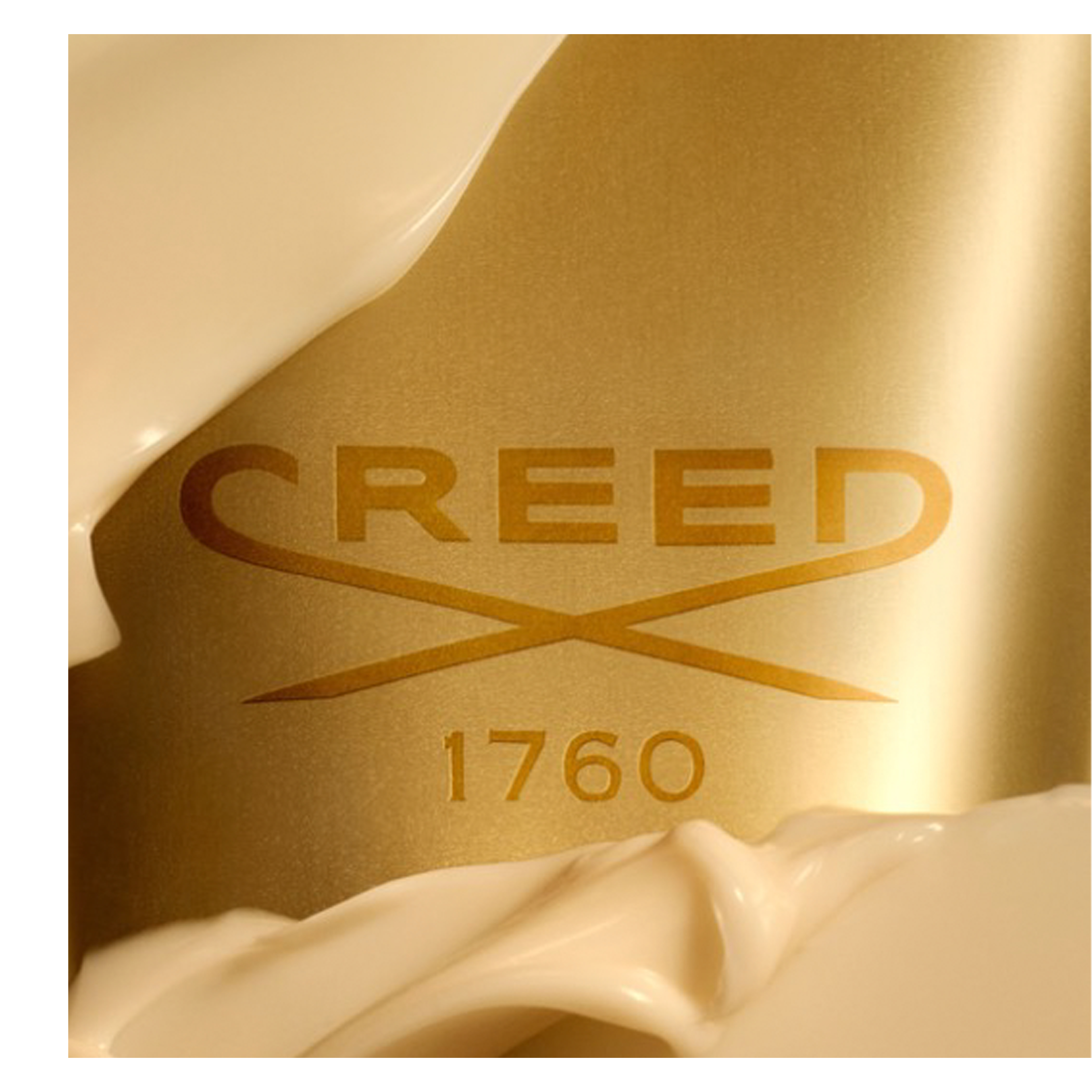 A gold surface partially covered by creamy white swirls, featuring the embossed text CREED, a crossed swords emblem, and 1760.