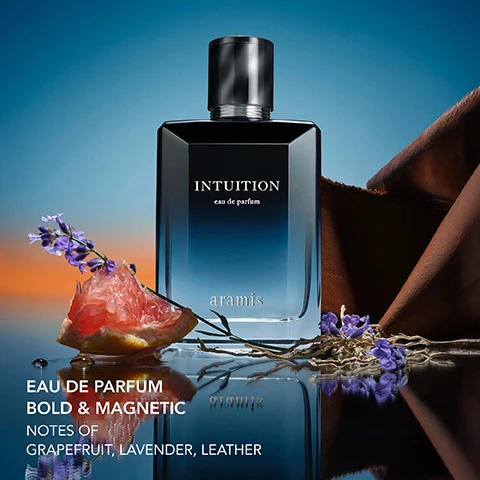 Image 1 - A bottle of Aramis Intuition perfume with grapefruit, lavender, and leather with text reading EAU DE PARFUM BOLD & MAGNETIC NOTES OF GRAPEFRUIT, LAVENDER, LEATHER. Image 2 - Dwyane Wade stands beside a bottle of Aramis Intuition perfume against a blue background with the text Ask yourself...and listen. Intuition eau de parfum aramis aramis Starring DWYANE WADE. Image 3 - A close-up image of brown textured material with the text WARM & ADDICTIVE CUIRISSIMA LXR EXCLUSIVE ARAMIS ESSENCE overlaid. Image 4 - Close-up of a cut grapefruit section with water droplets showing juicy pink flesh with the text CRISP & INVIGORATING GRAPEFRUIT. Image 5 - Purple lavender flowers against a blue background with the text FRESH & ENERGIZING LAVENDER. Image 6 - Close-up of dry roots against a blue background with the text WOODY & EVOCATIVE VETIVER.