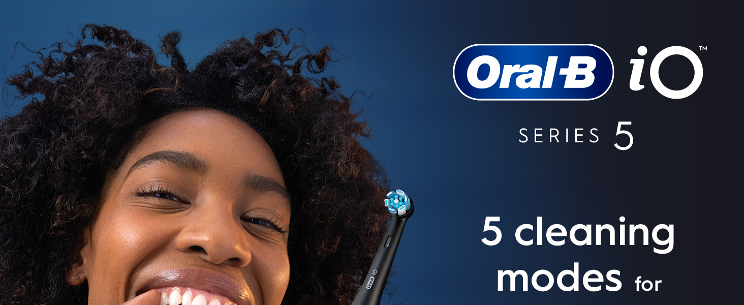 A smiling woman holds an Oral-B iO Series 5 electric toothbrush with the text Oral-B iO SERIES 5 5 cleaning modes for displayed.