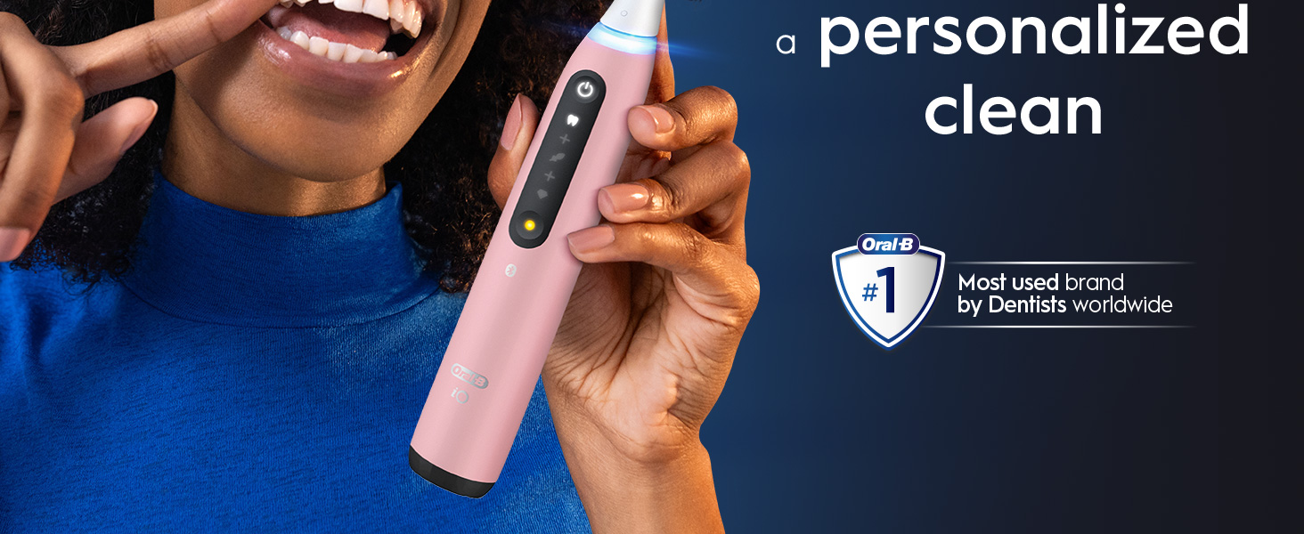 A hand holds a pink electric toothbrush near a persons mouth with text that says a personalized clean and Oral-B #1 Most used brand by Dentists worldwide.