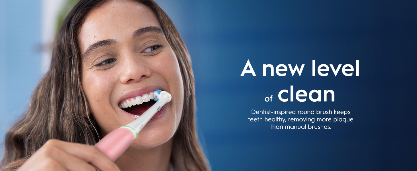 A woman smiles while brushing her teeth with a pink electric toothbrush, and the text reads A new level of clean. Dentist-inspired round brush keeps teeth healthy, removing more plaque than manual brushes.