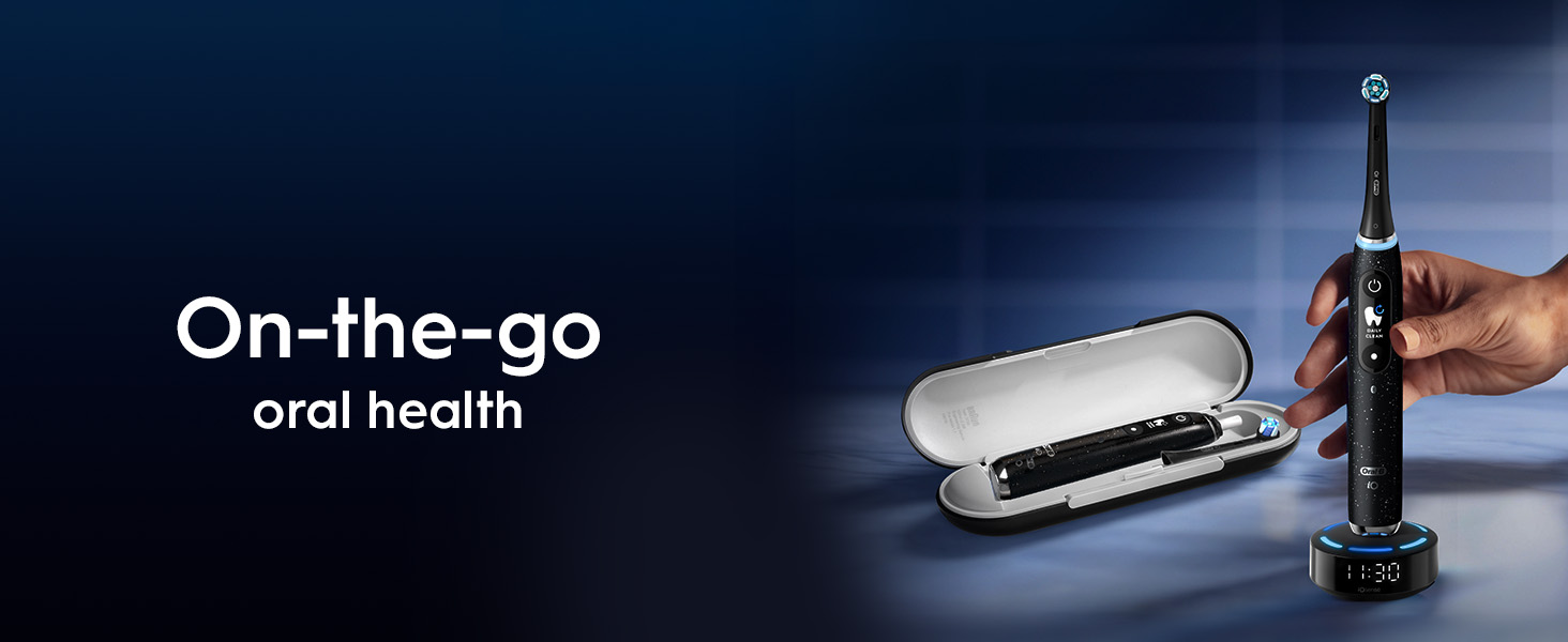 The image shows a black electric toothbrush in a travel case and another black electric toothbrush on a charging base held by a hand, with the text On-the-go oral health.