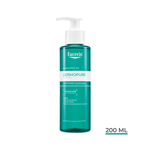 Image 1 - A teal pump bottle of Eucerin DermoPure Clinical Purifying Cleanser is shown, labeled for Blemish Prone Skin, containing Salicylic Acid 2% Respect, described as Gentle, Reduces Excess Oil And Blemishes, Suitable For Sensitive Skin Face & Body, Dermatological Skincare, and has a volume of 200 ML. Image 10 - The image displays a 3-step Eucerin skincare routine, featuring the Eucerin logo at the top right; Step 1, labeled Purifying Cleanser, shows a green bottle with text Eucerin Dermopure Purifying Cleanser, usable day and night; Step 2, labeled Triple Action, presents a white bottle with text Eucerin Dermopure Clinical Triple Action, usable day and night; and Step 3, labeled Oil Control SPF 50+, features an orange and white bottle with text Eucerin Sun Protection Oil Control Dry Touch Sun Gel-Cream Ultra Light 50+, usable during the day. Image 2 - A hand holds a teal Eucerin DermoPure cleanser bottle, dispensing clear liquid into the palm of another hand, with visible text reading Eucerin, ACNE-PRONE SKIN, DERMOPURE, CLEANSER, MATTIFYING FINISH, NON-COMEDOGENIC, and SUITABLE ON SENSITIVE SKIN. Image 3 - A teal Eucerin DermoPure Clinica Purifying Cleanser bottle, labeled for ACNE-PRONE SKIN with SALICYLIC ACID + PH RESPECT and described as GENTLE, Reduces excess oil and, stands next to text indicating -49% COMEDONES¹ and 0% SOAP FRAGRANCE OIL, with the Eucerin logo at the top right and a footnote explaining ¹ Clinical study, lesion count, 23 volunteers, 12 weeks of use twice daily, compared to baseline. Image 4 - A smiling woman with braided hair holds a green Eucerin Dermopure Clinical Purifying Cleanser bottle, with text beside her listing Face & Body Efficacy: -63% Appearance of Pores¹, -49% Comedones², and -46% Oiliness¹. Image 5 - A person washes their face with white foam on their cheek, with the visible text Eucerin Gentle Cleansing Gel Controls Oil & Blemishes from DAY 1. Image 6 - An image displays two Eucerin Dermopure Purifying Cleanser bottles, the old one in a light green bottle on the left and the new one in a dark teal bottle on the right, with visible text Eucerin NEW LOOK SAME FORMULA OLD NEW. Image 7 - The image shows a hand in a white lab coat holding a teal Eucerin DermoPure Purifying Cleanser bottle, with the visible text RECOMMENDED BY DERMATOLOGISTS FOR OILY TO BLEMISH-PRONE SKIN, the Eucerin logo, and on the bottle itself, the text Eucerin ACNE-PRONE SKIN DERMOPURE CLINICAL PURIFYING CLEANSER SALICYLIC ACID 2% RESPECT GENTLE Reduces excess of oil and blemishes Unclogs pores SENSITIVE SKIN FACE & BODY DERMATOLOGICAL SKINCARE. Image 8 - The image displays a teal liquid surface with ripples, and text reading Eucerin, With correcting SALICYLIC ACID, Dissolves & removes dead skin, Opens up and prevents clogged pores. Image 9 - Two panels display skincare ingredients: a wavy teal liquid on the left representing Salicylic Acid To exfoliate and unclog blocked pores, and a clear viscous liquid on the right representing Dermo-Acids AHA + PHA To significantly enhance the skins appearance, with the Eucerin logo in the top right.