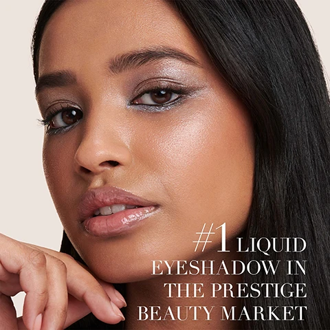 Image 1 - A close-up of a woman with shimmering silvery eyeshadow and glossy lips, with text that reads #1 LIQUID EYESHADOW IN THE PRESTIGE BEAUTY MARKET. Image 2 - Two sleek black Giorgio Armani beauty products, an eye tint and a mascara, are displayed on a light background, accompanied by text that reads: STEP 1: EYE TINT The Viral eyeshadow Smokey eyes and intense colour in one stroke. STEP 2: VERTIGO LIFT MASCARA Clump-Free sculpted length for up to +70% visibly longer lashes.