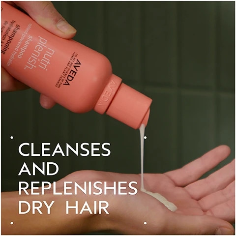Image 1 - A hand holds a coral-colored shampoo bottle, pouring a stream of light-colored product into an open palm, with the visible text nutriplenish, Aveda, Shampoo, CLEANSES AND REPLENISHES DRY HAIR. Image 2 - A hand holds a pink Aveda Nutriplenish conditioner tube, displaying text AVEDA THE ART AND SCIENCE OF PURE FLOWER AND PLANT ESSENCES nutri plenish conditioner nutrient-powered hydration après-shampooing hydratation à base de nutriments light moisture hydratation légère 8.5 fl oz/oz liq/250 ml e, next to large white text on a dark background that states CONDITIONS AND REPLENISHES DRY HAIR. Image 3 - A hand holds an orange Aveda Nutriplenish leave-in conditioner spray bottle with text that reads AVEDA THE ART AND SCIENCE OF PURE FLOWER AND PLANT ESSENCES, nutri plenish. leave-in conditioner nutrient-powered hydration detangles & protects. après-shampooing sans rinçage hydratation à base de nutriments démêle et protège. all hair types tous types de cheveux, beside large white text stating INSTANTLY HYDRATES, DETANGLES, AND PROTECTS ALL HAIR TYPES AND TEXTURES. Image 4 - Image displays a dark green to purple gradient background with subtle sparkling lights, featuring a circular Aveda vegan logo, a flask with a plant sprout, and a Cruelty Free International rabbit logo, with text that reads: EMBRACE THE TRUE SPIRIT OF CARE. Gift high-performance hair and body care crafted with naturally derived ingredients. VEGAN. AVEDA. 96% NATURALLY DERIVED. CRUELTY FREE INTERNATIONAL. *On average, naturally derived per ISO 16128 standard, based on volumes sold. From plant sources, non-petroleum mineral sources, and/or water.