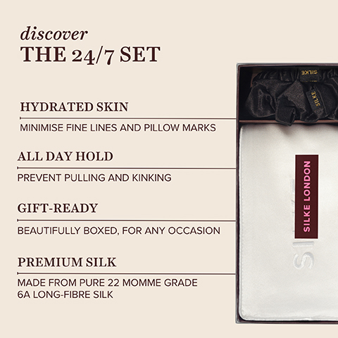 A product image showing a partially open dark box on the right, containing black silk scrunchies with the word SILKE and a white folded silk pillowcase with a vertical SILKE LONDON label, alongside text on the left that reads discover THE 24/7 SET, HYDRATED SKIN MINIMISE FINE LINES AND PILLOW MARKS, ALL DAY HOLD PREVENT PULLING AND KINKING, GIFT-READY BEAUTIFULLY BOXED FOR ANY OCCASION, PREMIUM SILK MADE FROM PURE 22 MOMME GRADE 6A LONG-FIBRE SILK.