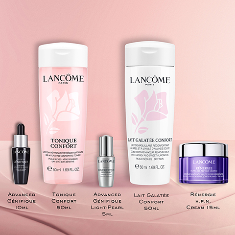 A collection of five Lancôme skincare products is displayed on a pink background, including a black dropper bottle with text Lancôme Génifique and a label Advanced Génifique 10ML, a large pink bottle with a rose design and text Lancôme Paris Tonique Confort Lotion Rehydratante Recomfortante Peaux Seches - Même Sensibles Dry Skin - Even Sensitive e 50 ml 1.69 FL OZ and a label Tonique Confort 50ml, a small silver dropper bottle with text Lancôme Génifique Yeux Light-Pearl and a label Advanced Génifique Light-Pearl 5ML, a large white bottle with a rose design and text Lancôme Paris Lait Galatée Confort Lait Demaquillant Reconfortant Au Miel Et A LHuile DAmande Douce Comforting Makeup Remover Milk With Honey And Sweet Almond Oil Peaux Sèches - Dry Skin e 50 ml 1.69 FL OZ and a label Lait Galatée Confort 50ml, and a purple jar with a silver lid with text Lancôme Rénergie H.P.N. 300-Peptide Cream and a label Rénergie H.P.N. Cream 15ML.