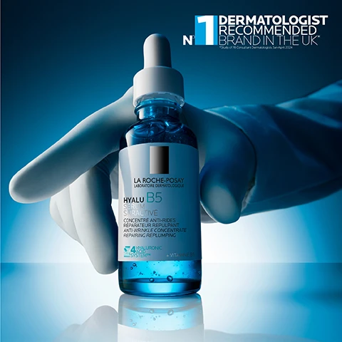Image 1 - A hand in a white glove holds a blue glass dropper bottle of serum, with the visible text N°1 DERMATOLOGIST RECOMMENDED BRAND IN THE UK* *Study of 78 Consultant Dermatologists Sept 2021, and the bottle label reading LA ROCHE-POSAY LABORATOIRE DERMATOLOGIQUE HYALU B5 SERUM SYNERGIE DACTIFS CONCENTRÉ ANTI-RIDES RÉPARATEUR REPULPANT ANTI-WRINKLE CONCENTRATE REPAIRING REPLUMPING 4 HYALURONIC ACID SYSTEM™ + VITAMINE B5. Image 10 - An image displaying the La Roche-Posay Laboratoire Dermatologique logo above four blue line icons representing product features: a doctor with a stethoscope next to Recommended by Dermatologists, a face with a hand touching its cheek next to Suitable for Sensitive Skin, a crossed-out droplet next to Alcohol Free, and a crossed-out pore next to Non-Comedogenic. Image 2 - A blue image shows a La Roche-Posay Hyalu B5 serum bottle and text that reads 1H REPAIR & REPLUMP**, 1 WEEK WRINKLE CORRECTION***, * Instrumental test, 24 subjects, ** Clinical study, 40 subjects, *** Clinical study, 62 subjects, LA ROCHE-POSAY LABORATOIRE DERMATOLOGIQUE, HYALU B5 SERUM SURACTIVE, CONCENTRE ANTI-RIDES REPARATEUR REPULPANT ANTI-WRINKLE CONCENTRATE REPAIRING REPLUMPING, 2 HYALURONIC ACID SYSTEM + VITAMIN B5. Image 3 - An image divided into two abstract sections shows a deep blue liquid-like pattern on the left with text HYALURONIC ACID and HELPS RETAIN SKIN MOISTURE, REPLUMP SKIN AND CORRECT WRINKLES, and a light green swirling pattern on the right with text VITAMIN B5 and HELPS TO REPAIR THE SKIN BARRIER. Image 4 - A close-up of a persons face with dark skin shows a hand touching the cheek with serum droplets, and text indicating Fresh and fast-absorbing light water serum, Instant lifting effect, and Wrinkle correction repair & replump. Image 5 - A dark background image featuring an abstract blue bubble-like shape on the right and a teal logo with the text 4 HYALURONIC ACID SYSTEM™, POWERED BY H.A. STIMULATING COMPLEX on the left. Image 6 - A blue glass bottle of La Roche-Posay Hyalu B5 Serum with a white dropper top is centered on a reflective surface against a deep blue background, with text on the bottle label reading LA ROCHE-POSAY LABORATOIRE DERMATOLOGIQUE HYALU B5 SERUM RÉPARATEUR REPULPANT ANTI-WRINKLE CONCENTRATE REPAIRING REPLUMPING 4 HYALURONIC ACID SYSTEM + VITAMIN B5, and large white text to the right detailing product claims: 76% AGREE SKIN LOOKS MORE PLUMPED* AFTER 1ST USE, 85% AGREE FINE LINES LOOK REDUCED* AFTER 7 DAYS, 98% AGREE SKIN FEELS SMOOTHER* AFTER 1 MONTH, followed by a small disclaimer *Self Assessment, 85 subjects. Image 7 - Three blue La Roche-Posay Hyalu B5 skincare products, a serum bottle, a cream jar, and an eye serum bottle, are shown arranged from left to right with large blue numbers 1, 2, and 3 above them, and the visible text below each product reads 1 HYALU B5 SURACTIVATED SERUM, 2 HYALU B5 SURACTIVATED CREAM, and 3 HYALU B5 EYE SERUM. Image 8 - A hand points to the top of a blue dropper bottle of La Roche-Posay Hyalu B5 serum, with its label displaying LA ROCHE-POSAY LABORATOIRE DERMATOLOGIQUE HYALU B5 SERUM ANTI-RIDES RÉPARATEUR REPULPANT ANTI-AGING CONCENTRATE REPLUMPING REPAIRING, a B5 icon, HYALURONIC ACID B5 CONCENTRATE, 14ml e 0.47 FL.OZ., and on the left side of the image, prominent black text reads APPLY 3-4 DROPS ON FACE AND NECK IN THE MORNING AND EVENING. Image 9 - A blue dropper bottle of La Roche-Posay serum is positioned against a background showing a gradient of four different skin tones, with visible text reading HYALU B5 SURACTIVATED SERUM SUITABLE FOR ALL SKIN TYPES LA ROCHE-POSAY LABORATOIRE DERMATOLOGIQUE HYALU B5 SERUM SURACTIVE CONCENTRE ANTI-RIDES REPARATEUR REPULPANT ANTI-WRINKLE CONCENTRATE REPAIRING REPLUMPING 4 HYALURONIC ACIDS SYSTEM TM + VITAMIN B5 30 ml.