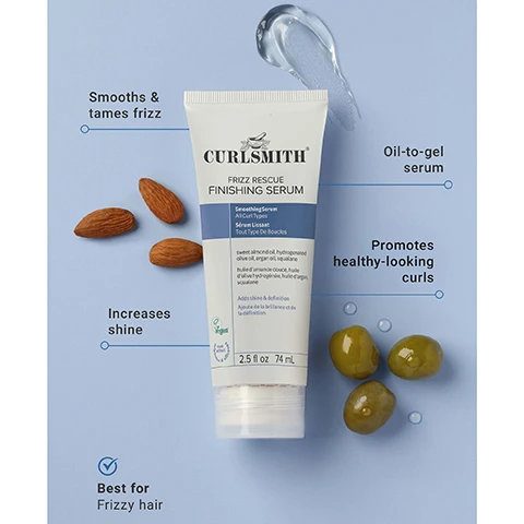 Image 1 - A white tube of Curlsmith Frizz Rescue Finishing Serum is shown on a light blue background, surrounded by three almonds, three green olives, and a dollop of clear serum, with descriptive text highlighting it as an Oil-to-gel serum that Smooths & tames frizz, Increases shine, Promotes healthy-looking curls, and is Best for Frizzy hair. The product label reads: CURLSMITH FRIZZ RESCUE FINISHING SERUM, Smoothing Serum All Curl Types, Sérum Lissant Tout Type De Boucles, Adds shine & definition, Ajoute de la brillance et de la définition, Vegan, 2.5 fl oz 74 mL. Image 2 - A smiling woman with curly, light brown hair holds a white and blue tube of Curlsmith Frizz Rescue Finishing Serum against a light blue background, with text in the upper left reading Controls frizz up to 72 HRS*. Image 3 - A hand squeezes a white tube of Curlsmith Frizz Rescue Finishing Serum, dispensing a clear gel into the palm of the other hand, with the text ANTI-HUMIDITY PROTECTION above. The tube displays the text CURLSMITH, FRIZZ RESCUE FINISHING SERUM, Smoothing Serum, All Curl Types, Sérum Lissant, Tout Type De Boucles, sweet almond oil, hydrogenated olive oil, argan oil, squalane, huile damande douce, huile dolive hydrogénée, huile dargan, squalane, Adds shine, Ajoute de la brillance, Vegan, 2.5 fl oz, and 74 mL. Image 4 - A white tube of Curlsmith Frizz Rescue Finishing Serum stands on a blue pedestal with almonds and olives to its sides, against a light blue background with a clear wavy panel, and includes text reading Reduces frizz by 65%*, CURLSMITH, FRIZZ RESCUE, FINISHING SERUM, Smoothing Serum All Curl Types, Sérum Lissant Tous Type De Boucles, sweet almond oil, hydrogenated olive oil, argan oil, squalane, huile d’amande douce, huile d’olive hydrogénée, huile d’argan, squalane, Adds shine & definition, Ajoute de la brillance et de la définition, a Certified Vegan logo, 2.5 fl oz 74 mL. Image 5 - A side-by-side comparison image shows two white tubes of Curlsmith Frizz Rescue Finishing Serum, the tube on the left representing the old packaging with green accents against a light green background displaying the text Curlsmith Anti-Frizz Recipe / Recette Anti-Frisottis Frizz Rescue Finishing Serum Shine And Define Smoothing Serum All Curl Types, under WHATS INSIDE and CONTENT, SWEET ALMOND OIL HYDROGENATED OLIVE OIL ARGAN OIL SQUALANE HUILE DAMANDE DOUCE HUILE DOLIVE HYDROGÉNÉE HUILE DARGAN SQUALANE, featuring cruelty free and VEGAN logos, and Zero Spoons Of Sulfates, Parabens, Silicones, Mineral Oils, Phthalates, DEA Zero Gramme De Sulfate, Parabène Silicone, Huile Minérale, Phtalate, DEA, and 2.5 fl oz / 74 mL; a blue arrow points right towards the new packaging tube on the right with blue accents against a light blue background, which displays a blue circular label above it that reads SAME GREAT NEW LOOK PRODUCT, and the tube itself shows Curlsmith Frizz Rescue Finishing Serum Smoothing Serum All Curl Types SWEET ALMOND OIL, HYDROGENATED OLIVE OIL, ARGAN OIL, SQUALANE HUILE DAMANDE DOUCE, HUILE DOLIVE HYDROGÉNÉE, HUILE DARGAN, SQUALANE Adds shine & definition Ajoute de la brillance et de la définition, a Vegan logo, and 2.5 fl oz 74 mL.