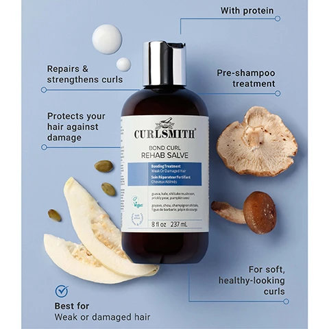 Image 1 - A product shot features a brown bottle of Curlsmith Bond Curl Rehab Salve with a silver cap, surrounded by shiitake mushrooms, pumpkin seeds, a slice of a light-colored melon, and two white drops, all against a light blue background, with text callouts reading: With protein, Repairs & strengthens curls, Pre-shampoo treatment, Protects your hair against damage, For soft, healthy-looking curls, Best for Weak or damaged hair, and the bottle label reads: CURLSMITH BOND CURL REHAB SALVE, Bonding Treatment, Weak Or Damaged Hair, Soin Réparateur Fortifiant, Cheveux Abimés, Vegan, proline, kale, shiitake mushroom, prickly pear, pumpkin seed, proline, chou, champignon shiitake, figue de barbarie, pépin de courge, 8 fl oz 237 mL. Image 2 - The image shows a side-by-side comparison of two brown bottles of Curlsmith Bond Curl Rehab Salve, the old packaging with a cream label on a light purple background on the left and the new packaging with a white label on a light blue background on the right, with a blue arrow pointing right between them; visible text includes a blue circular label stating Same Great New Look Product, the old bottles label reading CURLSMITH STRENGTH RECIPE / RECETTE FORTIFIANTE BOND CURL REHAB SALVE Bonding Treatment Weak Or Damaged Hair Soin Réparateur Fortifiant Cheveux Affaiblis GUAIA, KALE, SHIITAKE MUSHROOM, PRICKLY PEAR, PUMPKIN SEED VÉGAN 8 fl oz 237 mL, and the new bottles label reading CURLSMITH BOND CURL REHAB SALVE Bonding Treatment Weak Or Damaged Hair Soin Réparateur Fortifiant Cheveux Affaiblis gojiva, kale, shiitake mushroom, prickly pear, pumpkin seed goyave, chou, champignon shiitake, figue de barbarie, pepin de courge Vegan 8 fl oz 237 mL.