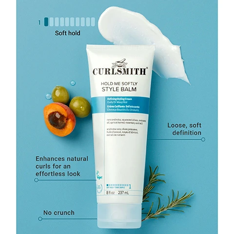 Image 1 - A white tube of Curlsmith Hold Me Softly Style Balm is displayed on a light blue background, accompanied by a dollop of white cream, green olives, a halved apricot, and a rosemary sprig, with visible text including CURLSMITH HOLD ME SOFTLY STYLE BALM, Defining Styling Cream Curly Or Wavy Hair, Crème Coiffante Définissante Cheveux Bouclés Ou Ondulés, rare and rich, squeezed olives, avocado oil, apricot kernel, rosemary extract, androbe rare, olives pressées, huile davocat, noyau dabricot, extrait de romarin, Vegan, 8 fl oz 237 mL, SOFT HOLD TENEUR SOUPLE 1, Soft hold with a corresponding graphic, Loose, soft definition, Enhances natural curls for an effortless look, and No crunch. Image 2 - A smiling woman with blonde curly hair holds a white tube of Curlsmith Hold Me Softly Style Balm against a blue background, with text that reads Our Top Selling Curl Cream For beautiful soft definition. Image 3 - A hand holds a white tube of Curlsmith Hold Me Softly Style Balm with cream dripping from its cap, set against a teal background, while text on the image reads Laced with nourishing CURL-LOVING INGREDIENTS, and text on the tube further includes Defining Styling Cream, Curly Or Wavy Hair, Crème Coiffante Définissante, Cheveux Bouclés Ou Ondulés, Contains andiroba, araráuva, avocado oil, apricot kernel oil, rosemary extract, contient andiroba, araráuva, huile davocat, huile de noyau dabricot, extrait de romarin, Vegan, 8 fl oz 237 mL. Image 4 - The image shows a side-by-side comparison of two Curlsmith Hold Me Softly Style Balm tubes, the old cream-colored packaging with an orange banner on the left, and the new white packaging with a blue banner on the right, separated by a teal arrow, and a teal circle overlay states Same Great New Look Product. Both tubes display Curlsmith Hold Me Softly Style Balm, Defining Styling Cream Curly Or Wavy Hair, Crème Coiffante Définissante Cheveux Bouclés Ou Ondulés, soft hold / tenue souple, 8 fl oz / 237 mL. The old packaging also features Moisture Recipe / Recette Hydratante, Cruelty Free, and Vegan, with its ingredients listed as RASP ANDIROBA, SQUEEZED OLIVES, AVOCADO OIL, APRICOT KERNEL, ROSEMARY EXTRACT. The new packaging shows Cruelty Free, with its ingredients listed as rare andiroba, squeezed olives, avocado oil, apricot kernel, rosemary extract.
