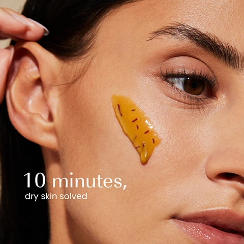Image 1 - A close-up of a persons face with a yellow gel product containing red specks applied to their cheek, next to the white text 10 minutes, dry skin solved. Image 2 - A dark green jar of izil Golden Honey & Saffron Moisturising Face Mask, which states Nourish, Moisturise & Soothe and Masque Visage Hydratant au Miel, Amande & Safrran, is displayed with a piece of honeycomb, a clear container of honey, a beaker of almonds, and a small beaker of saffron threads, with additional text reading Argan Oil, Jojoba Oil, and Probiotics. Image 3 - A persons hands are shown holding a dark green jar, with a finger scooping out the thick golden-brown face mask, next to text that reads Illuminates skin, Moisturises, Soothes, and on the jar label, Izil GOLDEN HONEY & SAFFRON MOISTURISING FACE MASK, NOURISH, MOISTURISE & SOOTHE, MASQUE VISAGE HYDRATANT AU MIEL, SAFFRAN ET REPARATEUR, قناع مرطب للوجه بالعسل والزعفران و مرمم. Image 4 - Close-up of a thick, wavy, golden-brown liquid with tiny dark red specks, displaying the text: 79.70% ORGANIC HALAL ALCOHOL-FREE CRUELTY-FREE FREE FROM GMOS, ALCOHOL, ARTIFICIAL COLOURS & FRAGRANCE. Image 5 - Four Izil brand skincare products are artfully arranged on a light brown surface with natural decor like saffron, almonds, honeycomb, and white flowers, with each product category labeled Plump, Nourish, Moisturise, and Exfoliate, and product text reading izil GOLDEN HONEY & HA HYDRATING TONER HYDRATE PLUMP & SOOTHE, izil GOLDEN HONEY & SAFFRON YOUTH RADIANCE FACE MASK NOURISH BRIGHTEN & MOISTURISE, izil PURE REGENERATING PRICKLY PEAR OIL REPLENISH FIRM & GLOW, and izil GOLDEN HONEY NOURISHING ALMOND SCRUB EXFOLIATE MOISTURISE & NOURISH. Image 6 - The image presents two jars of izil face mask, illustrating a packaging change, with the text New Look Same formula you love; the jar on the left has a label reading izil MOISTURIZE GOLDEN HONEY MASK izil PURE NATURAL & HOME CO. NOURISH, MOISTURIZE & SOOTHE NORMAL + DRY SKIN, and the jar on the right has a label reading izil GOLDEN HONEY & SAFFRON MOISTURISING FACE MASK NOURISH, MOISTURISE & SOOTHE ماسك العسل الذهبي والزعفران المرطب يغذي يرطب ويهدئ.