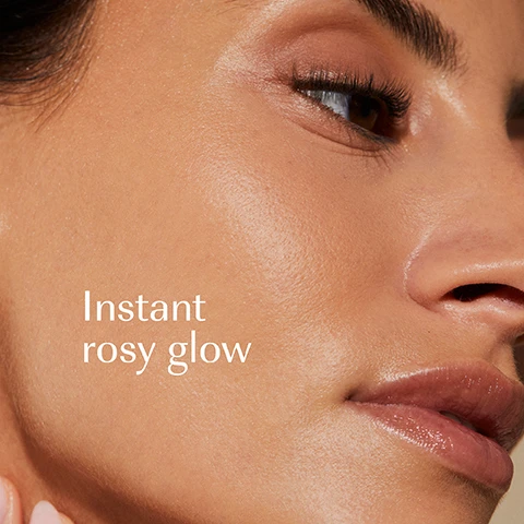 Image 1 - A close-up of a persons face with glowing, radiant skin and glossy lips, with the text Instant rosy glow. Image 2 - A dark green jar of Izil Aker Fassi Instant Glow Face Mask sits on a stone slab with a red hibiscus flower behind it and a honey dipper dripping honey, with text reading Izil Aker Fassi Instant Glow Face Mask Hydrate, Boost Skin Elasticity & Glow. Non-toxic without vitamins delay immediate & lasting results, Manuka Honey, Hibiscus, Moroccan Lava Clay. Image 3 - A persons hand with light pink manicured nails holds a black jar of face mask, with a finger scooping out a generous amount of pinkish-red mask product; visible text reads izil AKER FASSI INSTANT GLOW FACE MASK HYDRATE, BOOST SKIN ELASTICITY & GLOW BENEFITS MASQUE VISAGE ECLAT INSTANTANÉ À LAKER FASSI لترطيب، تعزيز مرونة البشرة وفوائد الإشراق Strengthens skin barrier Instantly adds glow Improves elasticity. Image 4 - A close-up of textured peachy-pink creamy cosmetic product with white text saying 98% NATURAL, HALAL, NATURAL PIGMENT, CRUELTY-FREE, FREE FROM GMOS, ARTIFICIAL COLOURS AND FRAGRANCE. Image 5 - A skincare product display on a stone slab with natural ingredients including a red poppy flower, rice, a plum, a prickly pear fruit, and a grapefruit slice, featuring four Izil products: a teal tube labeled izil AHA & ALGAE EXFOLIATING DAILY CLEANSER EVEN SKIN TONE PORE MINIMIZE BRIGHTEN ALL SKIN TYPES, an orange bottle labeled izil AKER FASSI & RICE PROTEIN GLOW TONER RADIANT BOOST & CLEAR SKIN ALL SKIN TYPES, a small dark teal jar labeled izil AKER FASSI & ARGAN LIGHTWEIGHT GLOW CREAM ALL SKIN TYPES, and a large dark teal jar labeled izil AKER FASSI INSTANT GLOW FACE MASK ALL SKIN TYPES, accompanied by text labels Exfoliate, Tone, Moisturise, Mask. Image 6 - An image comparing two skincare product jars, illustrating a new packaging design, with the text New Look Same formula you love; the old packaging on the left is a clear jar with pink contents and a teal label reading izil AKER FASSI BRONZE REVITAL RADIANCE BOOST ELASTICITY & SUPPORT HEALTHY METABOLISM ALL SKIN TYPE, while the new packaging on the right is a dark gray jar with a speckled teal lid and label reading izil AKER FASSI INSTANT GLOW FACE MASK HYDRATE BOOST SKIN ELASTICITY & GLOW قناع الوجه الفوري لتفتيح وشد البشرة.