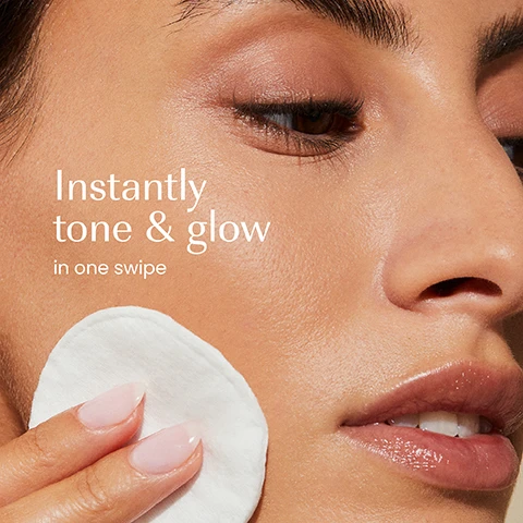 Image 1 - A close-up of a persons face with clear, glowing skin, applying a white cotton pad to their cheek, with the text Instantly tone & glow in one swipe. Image 2 - A translucent coral-colored Izil toner bottle with a dark green cap stands on a beige stone slab, accompanied by a test tube filled with rice grains and a small glass containing pink liquid and a white rose, with visible text including DAMASK ROSE WATER, RICE PROTEIN, RED ALGAE, and on the bottle: izil, AKER FASSI & RICE PROTEIN GLOW TONER, DEEP CLEAN PORES, STRENGTHEN SKIN & GLOW INSTANTLY, Rice Protein, Red Algae, Damask Rose Water, TONIFIANT ÉCLAT À AKER FASSI ET AUX PROTÉINES DE RIZ, يوفر اشراق عميق للبشرة ويقويها فورا, ALL SKIN TYPES. Image 3 - A hand holds a red izil bottle with a black cap, featuring text that reads Deep cleans pores, Refines texture, Balances, izil, AKER FASSI & RICE PROTEIN GLOW TONER, DEEP CLEAN PORES, STRENGTHEN SKIN & GLOW INSTANTLY, Rice Protein, Red Algae, Damascus Rose Water, TONIFIANT ÉCLAT À LAKER FASSI ET AUX PROTÉINES DE RIZ, تـونــر الــوجــه الـفـاسـي وبـروتـيـن الأرز لـلـإشـراقـة, ALL SKIN TYPES. Image 4 - A vibrant orange-red image with bubbles on the left, displaying product features: 99.65% NATURAL HALAL NON-STRIPPING FORMULA CRUELTY-FREE FREE FROM GMOs, ALCOHOL, ARTIFICIAL COLOURS & FRAGRANCE. Image 5 - A collection of Izil skincare products is arranged on a stone slab with a red poppy, white rice grains, a pink prickly pear fruit, mango, and grapefruit slices; labels Exfoliate, Tone, Moisturise, and Mask point to the respective products, which include a teal tube with text izil AHA & ALGAE EXFOLIATING DAILY CLEANSER EVEN SKIN TONE PORE MINIMIZER RENEW BRIGHTEN ECOCERT ORGANIC COSMETIC [Arabic text] ALL SKIN TYPES izil.ae, an orange bottle with text izil AKER FASSI & RICE PROTEIN GLOW TONER HYDRATES, STRENGTHENS & MINIMIZES PORES [Arabic text] ALL SKIN TYPES izil.ae, a green jar with text izil AKER FASSI & ARGAN LIGHTWEIGHT GEL-CREAM [Arabic text] izil.ae, and a dark teal jar with text izil AKER FASSI INSTANT GLOW FACE MASK [Arabic text] izil.ae. Image 6 - The image shows a product packaging update, with an old clear bottle containing red liquid on the left labeled izil CHADIANCE AKER FASSI NEW TONER, and a new opaque red cylindrical bottle on the right labeled izil AKER FASSI & RICE PROTEIN GLOW TONER, displayed below the prominent text New Look, Same formula you love.