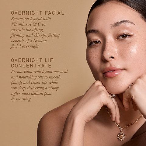 A woman with glowing skin, wearing a gold necklace, rests her chin on her hands, next to text that reads: OVERNIGHT FACIAL Serum-oil hybrid with Vitamins A & C to recreate the lifting, firming and skin-perfecting benefits of a Skinesis facial overnight OVERNIGHT LIP CONCENTRATE Serum-balm with hyaluronic acid and nourishing oils to smooth, plump, and repair lips while you sleep, delivering a visibly softer, more defined pout by morning.