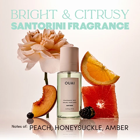 Image 2 - A light green OUAI Fragrance Mist bottle with a pink cap is surrounded by a pink flower, a slice of peach, an orange wedge, a grapefruit slice, a blackberry, and a blueberry, with the text Bright & Citrusy Santorini Fragrance, and Notes of: Peach, Honeysuckle, Amber. Image 3 - A woman with wavy blonde hair wears a beige bikini and holds a white bottle while standing in clear water, with the blue sky above, next to text that reads SMELLS LIKE: DIVING ALL THE OUAI IN WIND-SWEPT HAIR OUZO AL FRESCO YOURE APHRODITE. Image 5 - A hand holds a clear Ouai fragrance mist bottle, actively spraying, against a background of a blue sea, white buildings, and a blue-domed church, with visible text OUAI FRAGRANCE MIST BRUME PARFUMÉE SANTORINI 3.3 Fl Oz / 97 ml and SPRAY FOR AN INSTANT OUAI-CATION. Image 6 - A triptych image features a peach on the left, blackberries in the center, and a golden amber-like texture on the right, overlaid with text that reads Santorini, Top Notes Peach Orange Grapefruit, Middle Notes Honeysuckle Berries Rose, Base Notes Vanilla Amber Musk. Image 7 - Three Ouai mist bottles, including Santorini Fragrance Mist, St. Barts Hair & Body Mist, and Ibiza Fragrance Mist, are partially buried in sand surrounded by tropical fruit, a vanilla bean, and an orchid, with the text Spray for an Instant Ouai-Cation.