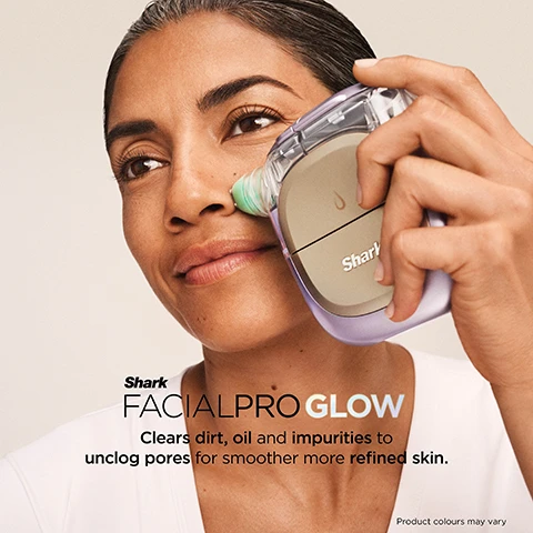 Image 1 - A woman is shown using a purple and beige Shark FacialPro Glow device with a green tip on her nose, with text that reads Shark FACIALPRO GLOW Clears dirt, oil and impurities to unclog pores for smoother more refined skin. Product colours may vary. Image 2 - A person is applying a beige and clear skincare device with a green head to their cheek, looking up and left, with visible text that reads: SPA LEVEL GLOW IN JUST 10 MIN, Clinically tested to boost hydration +128% in one use*, and *Results from clinical study with 60 subjects immediate use of treatment. Individual results may vary. Product colours may vary. Image 3 - A man uses a light purple and beige facial device on his cheek, with a close-up inset of his eye and an icon displaying a blue snowflake for Instachill and a red wave for Instaheat, with the text Shark DePuffi Helps contour the face and visibly depuff the under eyes for a brighter, more defined look, and Product colours may vary. Image 4 - A smiling person applies a clear gel product to their cheek, with a circular inset image showing the same person holding a white skincare bottle, displaying the text DERM DETOX, Supports spa-level exfoliation for clearer, cleaner pores, Shrank, DETOX, 1, Product colours may vary. Image 5 - A light blue Shark HYDRO INFUSE BIO-HYDRATION HYALURONIC ACID MIST bottle (30mL | 1.01 Fl. Oz.) with the number 2, stands beside a large clear liquid droplet that says HYDRO INFUSE Hyaluronic Acid (HA) helps infuse skin with hydration for firmness and luminosity.