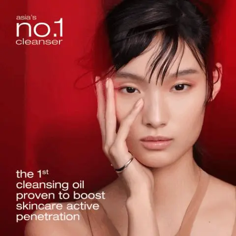 Image GIF1 - A young woman with dark hair looks forward, gently touching her face with one hand against a red background, with text reading asias no.1 cleanser and the 1st cleansing oil proven to boost skincare active penetration. Image GIF2 - A large golden liquid droplet with two smaller droplets on a light background, with the text nano-micelle technology for deep purification. Image GIF3 - A womans face is split vertically, showing one half with full makeup including red eyeshadow and deep red lipstick, and the other half completely bare, with the text superior removability including waterproof mascara. Image GIF4 - A close-up of a red flower with golden, translucent drops on its petals, showing the text ultra gentle cleansing with japanese camelia oil 94% serum in oil. Image GIF5 - An array of Shu Uemura x Final Fantasy XIV makeup products, including a black pump bottle, a lipstick, a small eyeshadow compact, and a large eyeshadow palette, all featuring neon blue and pink character art, displayed on a blue surface against a sparkling blue background, with visible text reading discover the full collection, shu uemura, FINAL FANTASY XIV, FINAL FANTASY XIV ONLINE, FINAL FANTASY XIV©SQUARE ENIX.