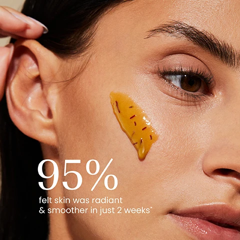 Image 1 - A close-up of a persons face with golden-yellow liquid containing dark specks applied to their cheek, showing text that reads 95% felt skin was radiant & smoother in just 2 weeks*. Image 2 - A hand scoops brown, grainy scrub from a jar labeled izil GOLDEN HONEY NOURISHING ALMOND SCRUB EXFOLIATE, MOISTURISE & NOURISH ARGAN OIL, SWEET ALMOND, WHEAT GERM GOMMAGE MIEL AMANDE NOURRISSANT & ÉCLATANT مقشر اللوز المغذي بالعسل الذهبي, with benefits listed on the right: Gently exfoliates, Illuminates skin, Moisturises, Plumps. Image 3 - Four izil skincare products, including a hydrating toner for Plump, a face mask for Nourish, an almond oil for Moisturise, and an almond scrub for Exfoliate, are artfully arranged on a beige surface with decorative saffron, almonds, honeycomb, and white flowers; visible text includes izil GOLDEN HONEY & HA HYDRATING TONER HYDRATE PLUMP & SOOTHE, izil GOLDEN HONEY & SAFFRON MOISTURIZING FACE MASK NOURISH MOISTURIZE & FIRM, izil PURE SWEET ALMOND OIL TONAL PROTECT & REVITALIZE, and izil GOLDEN HONEY NOURISHING ALMOND SCRUB EXFOLIATE MOISTURIZE & NOURISH.