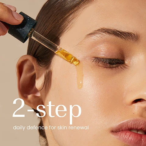 Image 1 - A close-up of a persons face with a hand applying golden liquid from a dropper onto their skin, with text that reads 2-step daily defence for skin renewal. Image 2 - A still life image shows two Izil brand dark green skincare products, a serum bottle and a cream jar, displayed on clear risers and a stone block with cut prickly pear fruit, a wheat stalk, and amber pieces around them, featuring text Plump, izil PRICKLY PEAR & OUD REJUVENATING FACE SERUM 30 ml e 1 fl.oz WITH MOROCCAN ARGAN OIL & 7 PLANT EXTRACTS FOR ALL SKIN TYPES 99.8% NATURAL & ORGANIC, and Firm, izil PRICKLY PEAR & OUD REGENERATING DAY CREAM 50 ml e 1.7 fl.oz WITH MOROCCAN ARGAN OIL & 7 PLANT EXTRACTS FOR ALL SKIN TYPES 99.8% NATURAL & ORGANIC.