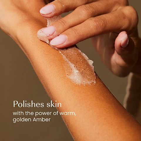 Image 1 - A persons hand with light pink nails applies a textured, brownish-white scrub to their forearm, with text reading Polishes skin with the power of warm, golden Amber. Image 2 - The image shows an Izil Amber Exfoliating Body Scrub jar on a stone platform, flanked by an amber-colored stone and argan nuts, with honeycomb and honey dripping from the top of the jar, and visible text includes SHEA BUTTER, ARGAN OIL, HONEY, izil, AMBER EXFOLIATING BODY SCRUB, EXFOLIATE, NOURISH & MOISTURIZE, Argan Oil, Shea Butter, Honey, NOURISHES, SMOOTHS & CLEANSES, يتغذى وينعم وينظف. Image 3 - A persons hands hold an open jar of light brown body scrub, with a finger scooping out some product, and text on the image reads Improves texture Nourishes Moisturises, izil AMBER EXFOLIATING BODY SCRUB EXFOLIATE, NOURISH & MOISTURISE Argan Oil, Shea Butter, Honey GOMMAGE CORPOREL EXFOLIANT À LAMBRE مقشر الجسم بالعنبر. Image 4 - A close-up of a textured, light brown creamy substance with small dark particles lists product benefits: 98.5% NATURAL, MICROPLASTICS-FREE, CRUELTY-FREE, FREE FROM GMOs, ALCOHOL, ARTIFICIAL COLOURS, SILICONE, PARABENS. Image 5 - Five izil Amber skincare products, including Cleansing Showergel, Exfoliating Body Scrub, Moisturising Body Lotion, Nourishing Dry Oil, and Hydrating Perfume Mist, are arranged on stone steps with amber pieces and ginger root, and are labeled above with Cleanse, Exfoliate, Moisturise, Nourish, and Refresh. Image 6 - The image displays a before-and-after comparison of Izil body scrub packaging, showing the old design on the left with a clear jar, black lid, and a label depicting a building, featuring text izil Second Nights in Marrakech ARGAN BODY SCRUB EXFOLIATE, NOURISH & MOISTURIZE with argan oil, shea butter, cocoa butter 250g / 8.8fl.oz, and the new design on the right with a frosted jar and light speckled lid, featuring text izil AMBER EXFOLIATING BODY SCRUB EXFOLIATE, NOURISH & MOISTURIZE with argan oil, shea butter, cocoa butter 250g / 8.8fl.oz LOTION CORPOREL EXFOLIANT A LAMBRE AVEC HUILE DARGAN, all under the main text New Look Same formula you love.