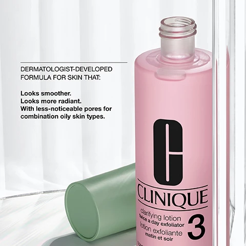 Image 2 - A pink Clinique Clarifying Lotion bottle with a black C logo and a green cylindrical container are displayed, with the visible text DERMATOLOGIST-DEVELOPED FORMULA FOR SKIN THAT: Looks smoother. Looks more radiant. With less-noticeable pores for combination oily skin types. C CLINIQUE clarifying lotion twice a day exfoliator lotion exfoliante matin et soir 3. Image 3 - A graphic displays two sections: the top section has an icon of wavy lines above the text exfoliate, and the bottom section has an icon of a magnifying glass above the text refine, all on a background of soft pink fluid shapes and white. Image 4 - A flat lay image showing a clear dish with white powder and another with a branch of yellow flowers, accompanied by the text Salicylic acid helps clear and unclog pores and Witch hazel helps refine skin. Image 6 - A pink image displays a list indicating product features with the text Free of fragrance oil.