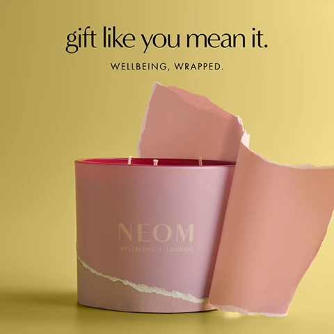 Image 1 - A large pink candle with three wicks is partially wrapped in torn pink paper on a yellow background, with the text gift like you mean it. WELLBEING, WRAPPED. above and NEOM WELLBEING | LONDON on the candle itself. Image 2 - A lit pink NEOM candle with the text NEOM WELLBEING | LONDON, and on the right side of the image, the text Its All Rosy Limited Edition Expertly blended with rose, geranium and orange. Image 3 - A pink three-wick candle with three lit wicks is shown next to its matching rose-patterned box against a yellow background, with visible text reading 100% naturally-derived wax with three 10ml bottles of essential oil blends in every 3 wick candle, NEOM WELLBEING | LONDON, ITS ALL ROSY SCENTED CANDLE, ROSE, GERANIUM & ORANGE, Scented Candle - Bougie Parfumée, 420 g e, and 14.8 oz. Image 4 - Two lit pink-glowing candles, one slightly out of focus, show the text Powered by 100% natural fragrances Super soothing scent to help spark moments of calm NEOM WELLBEING LONDON. Image 5 - A hand lights the third wick of a pink three-wick candle with two already lit, displaying the text: Caring for your candle. Always light all 3 wicks at the same time. Burn for a minimum of 2 hours and a maximum of 4. Trim wicks to about 1cm before lighting. NEOM WELLBEING | LONDON.