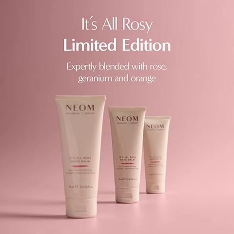 Image 1 - Three light pink tubes of Neom hand balm are displayed on a pink background, featuring the text Its All Rosy Limited Edition, Expertly blended with rose, geranium and orange, and on the tubes NEOM WELLBEING LONDON ITS ALL ROSY HAND BALM Rose, Geranium & Orange Hand Balm - Baume Pour Les Mains 75 ml e 2.5 US fl oz. Image 2 - A white tube of hand balm lies horizontally on a yellow surface with a small amount of white cream squeezed out, displaying text that reads Powered by 100% natural fragrances Super soothing scent to help spark moments of calm ITS ALL ROSY HAND BALM Rose, Geranium & Orange Hand Balm - Baume Pour Les Mains 75 mle 2.5 US fl. oz. NEOM WELLBEING | LONDON.