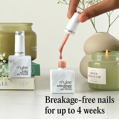 Image 1 - A hand drips peach-colored nail polish from a brush into an open bottle of Mylee Super Pigment Builder Gel Polish, positioned next to a Mylee 5-in-1 Builder Gel Polish bottle, a lit Fragrance Green Basilicum Exclusive Batch candle, an unlit Bergamot & Sandalwood candle, and white flowers in vases, with overlay text Breakage-free nails for up to 4 weeks. Image 2 - A hand with peach-colored nails is shown applying nail extension product using a silver form, with a white bottle displaying the text mylee, and overlaid text states Protect, strengthen and lengthen nails up to 1cm. Image 3 - The image displays five swatches of nail gel in shades of peach, light pink, hot pink, dusty rose, and reddish-brown, with text describing product features including: Easy to work with self-levelling formula that is both beginner and pro-friendly, Opaque finish, Cures in 99 seconds on low heat mode in the Mylee Grande LED Lamp, High-viscosity formula, Infill without full removal, and No drips or mess. Image 4 - Five mylee SUPER PIGMENT BUILDER GEL POLISH bottles with caps showing varying pink and peach shades are arranged on a light background, accompanied by icons for CRUELTY-FREE, VEGAN, and PROFESSIONAL RESULTS.