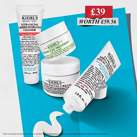 Image 2 - A set of Kiehls skincare products is presented on a blue background, featuring a Kiehls Ultra Facial Barrier-Hydrating Cleanser 1.0 fl. oz. - 30 mL tube, a Kiehls Creamy Eye Treatment with Avocado jar, a Kiehls Ultra Facial Cream jar, a Kiehls Ultra Body Mega Moisture Cream 1.0 fl. oz. - 30 mL tube with spilled cream, and a promotional offer of £39 WORTH £59.56. Image 3 - Four Kiehls skincare products are displayed on a white paper with a blue background, detailing ingredients and their benefits. Text on the paper reads: KIEHLS Our Products With: GLYCERIN Our formula helps to hydrate the skin barrier. PRO-CERAMIDES Our formula helps to fortify the skin barrier with moisture. SQUALANE Our formula helps replenish skin moisture barrier. AVOCADO OIL Our formula helps moisturise and nourish skin. Kiehls Since 1851. Image 4 - A four-panel collage showcases diverse individuals applying skincare products, highlighting benefits such as HELPS REPAIR skin barrier in 1-hour, DEEPLY hydrates SKIN, CLEANSES SKIN without stripping, and DE-PUFFS under eye. Image 5 - A flat lay image on a white surface with a blue edge displays the RECOMMENDED ORDER OF USE for four Kiehls skincare products: a white tube for 1 Deeply Cleanse using Ultra Facial Barrier-Hydrating Cleanser; an open green and white jar with yellow cream for 2 De-puffs under eye* with Creamy Eye Treatment with Avocado; a white jar for 3 Hydrate Face with Ultra Facial Cream; and a white tube with a dollop of cream for 4 Hydrate Body with Ultra Body Mega Moisture Squalane Cream, accompanied by the note *with massage. Image 6 - Four white Kiehls skincare products, including tubes and jars, are arranged on a blue surface with a wave of white cream squeezed from one tube, and the visible text states Kiehls Ultra Facial Barrier-Hydrating Cleanser 1.0 fl. oz. - 30 ml, Kiehls Creamy Eye Treatment with Avocado, Kiehls Ultra Facial Cream, Kiehls Ultra Body Mega Squalane Daily & Fortifying Cream 1.0 fl. oz. - 30 ml, €48, worth €57.64.