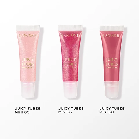 Image 1 - The image shows three Lancôme Juicy Tubes lip glosses: a pale pink, a glittery fuchsia, and a rosy red, with each tube displaying Lancôme Juicy Tubes Original, and labeled below as Juicy Tubes Mini 05, Juicy Tubes Mini 07, and Juicy Tubes Mini 08. Image 2 - The image displays a close-up of a persons glossy pink lips holding a lip gloss tube partially labeled Juicy Vibes, alongside three lip gloss swatches: a shimmery medium pink labeled Magic Spell, a shimmery light pink labeled Marshmallow Electro, and a solid dark pink labeled Tickled Pink. Image 3 - A pink glittery lip gloss squeezes from a tube, forming a dollop and a string, with the text Ultra Shiny Lip Gloss, 3 Shiny Finishes, Sparkle, Creamy & Jelly, Gloss On-The-Go. Image 4 - A smiling woman with closed eyes applies shimmery pink lip gloss to her lips, with visible text Magic Spell. Image 5 - A four-panel image shows a close-up of a persons lips with dark skin undergoing a makeup tutorial, featuring step-by-step application of lip liner, blending, and applying lip gloss to achieve a glossy finish, with the text A JUICY DUO LIP IDÔLE LIP SHAPER + JUICY TUBES STEP 1: LINE LIPS WITH LIP SHAPER SHADE 62 MORNING ESPRESSO STEP 2: BLEND LINER INTO LIPS STEP 3: APPLY JUICY TUBES SHADE MARSHMALLOW ELECTRO FINAL LOOK.