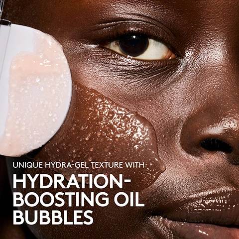 Image 1 - A close-up of a person with dark skin having a light pink, clear gel with bubbles applied to their cheek by a white applicator, with text that reads UNIQUE HYDRA-GEL TEXTURE WITH HYDRATION-BOOSTING OIL BUBBLES. Image 2 - A person with radiant, moisturized skin smiles, touching their face which is covered in a light, slushie-like product, while hands with light pink nails frame their face. The text on the left reads SKINS SUPER SLUSHIE, LOCKS IN MOISTURE FOR UP TO 72 HOURS, INSTANTLY + INTENSELY HYDRATES, IMPROVES MOISTURE BARRIER, IMPROVES SKIN ELASTICITY, *IN A 3-DAY CLINICAL STUDY ON 33 PEOPLE. Image 3 - A person with wet hair and skin smiles and looks upwards, with the text 96% AGREE IT DOESNT FEEL HEAVY ON SKIN and IN A 4-WEEK CLINICAL STUDY ON 52 PEOPLE. Image 4 - A close-up of a persons face shows a clear, bubbly liquid on their cheek, while a hand with light purple nails holds a white applicator against the cheek with text that reads 96% AGREE IT INSTANTLY LEAVES SKIN INTENSELY HYDRATED IN A 4-WEEK CLINICAL STUDY ON 52 PEOPLE. Image 5 - A jar of Fenty Skin Dew N Plump Slushie Mask with a purple lid and peach-colored product is centered on a pink background, with text that reads WHEN TO USE DEW N PLUMP SLUSHIE MASK and Late nights, dry days, non-stop travel— apply as the last step of your skincare routine for an instant hydration boost. Image 6 - A split image shows a persons face with skin before and instantly after treatment, with visible redness and blemishes on the left labeled BEFORE, and smoother, clearer skin on the right labeled INSTANTLY AFTER, followed by text that reads 94% AGREE IT REVIVES TIGHT, THIRSTY SKIN *IN A 4-WEEK CLINICAL STUDY ON 52 PEOPLE. Image 7 - A multi-panel image demonstrates how to use the Fenty Skin Dew N Plump Slushie Mask, showing diverse models applying the product in four steps from opening the jar to massaging it into their skin, alongside visible text that reads: HOW TO USE DEW N PLUMP SLUSHIE MASK STEP 1 Apply as the last step of your skincare routine STEP 2 Pull out the spatula and apply to entire face + neck STEP 3 Massage until all oil bubbles have burst PRO TIP: Designed to leave on, no need to rinse mask off STEP 4 Rinse spatula + replace in cap FENTY SKIN. Image 8 - The image features a Fenty Skin product jar with a coral base and purple lid, alongside ingredients including a clear liquid in a tall bottle, a star fruit slice, white dried fruit pieces, a beaker with yellow oil, cherries, and a slice of yellow watermelon, with descriptive text reading MADE WITH POLYGLUTAMIC + HYALURONIC ACIDS Mega-plumpers help hydrate + bind moisture to the skin, FENTY SKIN, SUPERQUENCH JUICE COMPLEX Replenishes, revives + plumps skin with hydration, KALAHARI MELON + BAOBAB OIL Encapsulated oil bubbles help hydrate, condition + nourish skin. Image 9 - A pink, watery background with ripples and water droplets features a Fenty Skin Dew N Plump Glow Serum pump bottle and a Fenty Skin Dew N Plump Slushie Mask jar, with text reading Your Hydrating, Dewy Duo, Dew N Plump Glow Serum, 3-in-1 daily serum, Gives skin an instant glow, Plumps skin with hydration instantly + over time*, *In a 4-week clinical study on 52 people, FENTY SKIN, Dew N Plump Hydrating Nectar Glow Serum, Syrume Eclat Au Nectar Hydratant, FENTY SKIN, Dew N Plump Slushie Mask, Leave-on gel mask, Instantly hydrates + locks in moisture up to 72 hours*, *In a 3-day clinical study on 33 people, Improves skin’s moisture barrier + elasticity.