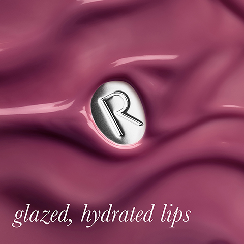 A close-up of a glossy, wavy berry-pink substance with a silver oval emblem featuring a stylized R, and the text glazed, hydrated lips.