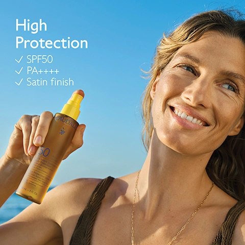 Image 1 - A smiling woman with sun-kissed skin holds a brown Caudalie SPF50 sunscreen spray bottle with a yellow top against a clear blue sky, featuring overlay text High Protection, SPF50, PA++++, Satin finish, and bottle text Caudalie, SPF50, Crème Solaire Visage et Corps Anti-Rides Peau Sensible, 150 mL - 5 fl. Oz. Image 2 - A person with wet skin wearing a dark swimsuit holds a yellow spray bottle labeled CAUDALIE PARIS, 50 against their hip at the beach, with overlay text that reads Face, body & hair Non-greasy & non-sticky. Image 3 - A Caudalie golden sunscreen spray bottle with a yellow cap stands on sand against a blurred blue ocean background, displaying text CollagenSkin Protect™, Antioxidant, preserve the skins collagen, CAUDALIE PARIS, 50 PA++++ SPF UVB+UVA, Huile Solaire Sublimatrice Haute Protection, Fini satiné. Bronzage éclatant. Résiste à l’eau. Visage, Corps, Cheveux., High Protection Glow Oil, Satin finish. Radiant tan. Water-resistant. Face, Body, Hair., CollagenSkinProtect™ Technology, 4 organic sunscreen filters, and Optimal broad-spectrum protection against UVA and UVB rays. Image 4 - A smiling woman with wet hair has a dab of white sunscreen on her left cheek, with a blurred beach scene in the background, and text that reads Water-resistant. Image 5 - A wet Caudalie SPF 50 sunscreen spray bottle with a yellow cap rests on a rock next to a coconut half and grapes, with the text New addictive sunny fragrance. Image 6 - The image shows two Caudalie SPF 50+ sun protection products, both Water Resistant and 150ml - 5 fl. Oz., perfect for Face, body & hair: on the left, a clear spray bottle of Very High Protection Sun Water with Vitis Vinifera Grape Water, offering an Invisible very high protection with a Light watery Texture; on the right, an amber spray bottle of High Protection Glow Oil with Vitis Vinifera Grape Oil, offering High Protection & radiant tan with an Oil with a satin finish Texture. Image 7 - A collection of Caudalie sun protection products in yellow, clear, and brown packaging is arranged on a stone ledge in front of a blue wall, with visible text including Suncare collection, Face protection, Face & body protection, and product labels such as CAUDALIE, SPF 50+ UVA UVB, SPF 30 UVA UVB, Very High Protection Cream, Invisible High Protection Spray, Hydrating Sun Water SPF50+, and Sun Oil SPF 50. Image 8 - A diagram on a yellow background illustrates how to recycle a product, showing an outline of a bottle with its cap removed, accompanied by the text: How to recycle Glow Oil SPF50+ Remove the pump and the cap, and recycle them with Terracycle at a Caudalie Boutique Spa Recycle the bottle in the recycling bin. Image 9 - A persons hands hold two crumpled plastic bottles, one blue and one teal, against a clear blue sky, with text that reads Caudalie collects and recycles as much plastic waste from the ocean as it generates as a brand, 100% OCEAN PLASTIC COLLECT.