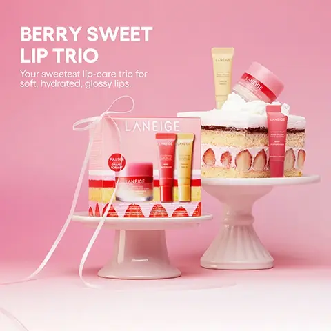 Image 1 - A Laneige Berry Sweet Lip Trio gift set and individual lip care products are arranged with strawberry shortcake slices on white cake stands against a pink background; visible text includes BERRY SWEET LIP TRIO, Your sweetest lip-care trio for soft, hydrated, glossy lips, LANEIGE, FULL SIZE ORIGINAL FORMULA, LANEIGE LIP SLEEPING MASK BERRY, LANEIGE LIP GLOWY BALM BERRY, LANEIGE LIP TREATMENT BALM GRAPEFRUIT, and LANEIGE LIP TREATMENT BALM. Image 2 - A slice of strawberry shortcake and a pink Laneige gift box with a jar and two tubes of lip products are displayed on a pink background, with cosmetic swatches on a plate, and visible text includes THE ICONIC TRIO, Lip Sleeping Mask Strawberry Shortcake, Lip Glowy Balm Berry & Vanilla, OPEN TO WONDER. LANEIGE, FULL SIZE GRAND FORMAT, LANEIGE, LIP SLEEPING MASK BERRY, and LIP GLOWY BALM VANILLA.