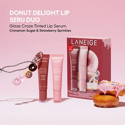 Image 1 - A Laniege Donut Delight Lip Seru Duo set with a brown lip serum tube, a pink lip serum tube, a donut-themed keychain, a red gift box with a donut illustration, and two real donuts (one pink-frosted, one plain) all set on a pink background, with visible text that reads DONUT DELIGHT LIP SERU DUO Glaze Craze Tinted Lip Serum Cinnamon Sugar & Strawberry Sprinkles LANEIGE GLAZE CRAZE TINTED LIP SERUM SERUM TEINT POUR LES LÈVRES CINNAMON SUGAR SUCRE CANNELLE STRAWBERRY SPRINKLES CONFETTIS FRAISE FULL SIZE GRAND FORMAT. Image 2 - A pink bag with a donut-themed keychain featuring four donut charms in dark brown, yellow swirl, iridescent pink heart, and light pink, plus a pink bow and silver charm, with the text DONUT DELIGHT KEYCHAIN Complimentary keychain to stay glazed and stylish wherever you go and Hand made.