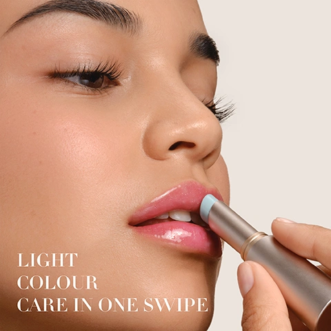 Image 1 - A close-up shows a persons hand applying a light blue lip product to glossy pink lips, with the text LIGHT COLOUR CARE IN ONE SWIPE. Image 2 - A split image shows a before and after comparison of a persons nose and mouth area, with natural pink lips on the left and shimmering pink lip gloss on the right. Text on the left reads BEFORE, and text on the right reads AFTER 01 ROSE FLASH. Image 3 - A light green lip balm in a silver tube with a gold band is shown against a glittery green and pink swiped background, with text that reads PH-REACTIVE PIGMENTS Adapts to the lips PH for your custom rosy shade and ARMANI on the tube. Image 4 - A light pink shimmery lip balm stick is shown open in a silver tube next to a swash of pink liquid, a droplet, and a single blueberry, with text that reads UP TO 24H HYDRATION, BLUEBERRY OIL, SQUALANE, SHEA BUTTER, and ARMANI on the tube.