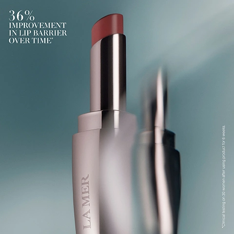 Image 6 - A silver tube of La Mer lip balm with a reddish-pink product extended, displaying the text 36% IMPROVEMENT IN LIP BARRIER OVER TIME* and *Clinical testing on 30 women after using product for 6 weeks. Image 7 - A close-up of a person with puckered lips wearing nude-pink lipstick, holding a rose gold La Mer lipstick tube, with overlay text saying 1 Apply directly onto lips as needed throughout the day and 2 Layer under The Lip Volumizer for a voluminous glow that plumps, hydrates and defines lips.