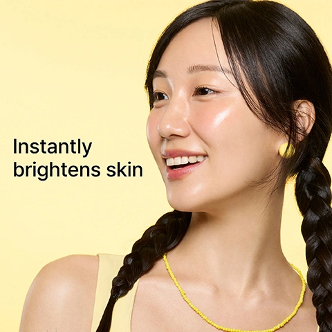 Image 1 - A smiling woman with radiant, dewy skin, dark hair in two braids, yellow stud earrings, and a yellow beaded necklace smiles against a yellow background, with the text Instantly brightens skin. Image 2 - A woman peels off the top layer of a cream-colored rubber face mask, revealing the bottom part covering her chin and jawline, with text that reads Step 1: Ampoule with brightening Niacinamide Step 2: Rubber mask cools skin. Image 3 - A split image shows a womans face before and after applying a brightening mask, with the left side showing her skin looking natural and the right side showing her skin with a dewy, radiant finish, accompanied by the text Cryo Rubber Brightening Mask, Cools and boosts radiance, Before, and After.