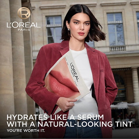 Image 1 - A woman in a red jacket holds a magazine displaying a close-up of pink lips, with a blurred classical building in the background, featuring the text LOréal Paris, HYDRATES LIKE A SERUM WITH A NATURAL-LOOKING TINT, and YOURE WORTH IT. Image 2 - A rose gold LOréal Hyaluron Tint lip serum is surrounded by translucent and opaque pink liquid shapes, with text that reads WATERY FLUSH OF COLOUR & HYALURONIC ACID, LOREAL PARIS HYALURON TINT LIP SERUM, ENHANCES LIPS WITH A NATURAL FLUSH OF COLOUR, UP TO 2X MORE HYDRATED LIPS*, and *Instrumental test, 24 women 15 minutes after application. Image 3 - A four-panel image shows a swatch of nude espresso lip color alongside three close-ups of lips demonstrating the products application: bare lips, lips with a glossy finish, and lips with a soft, hydrated tint, with visible text 485 NUDE ESPRESSO, BEFORE BARE LIPS, STARTS GLOSSY, SETS TO A HYDRATED SOFT TINT. Image 4 - A split image of a persons lips, with the left side showing a glossy light pink finish and the right side showing a soft reddish-brown hydrated tint, accompanied by the text STARTS GLOSSY on the left and HYDRATED SOFT TINT with a stylized R logo on the right. Image 5 - A close-up shows a pink plush applicator against a pink background with text that reads Plushy Applicator and For Smooth Application. Image 6 - A woman with rosy cheeks and smile lines smiles with squinted eyes, with text indicating blush application for a flushed look: MORE THAN 1 LOOK APPLY ON CHEEKS FOR FLUSHED BLUSH. Image 7 - A row of LOreal Paris Hyaluron Tint Lip Stain Serum bottles in various nude, pink, and red shades, with some caps removed showing the applicators, on a reflective surface against a white background, with the text Pick Your Hyaluron Tint Shade and a registered trademark symbol. Image 8 - Three hands with varying skin tones hold tubes of LOréal Paris Hyaluron Tint, with multiple swatches of different lip tint shades displayed on their arms: 601 Worth It, 635 Worth It Medium, 640 Tea Time, 485 Nude Espresso, 521 Bordeaux Please, 420 Le Rouge Paris, 490 Berry Jolie, 217 Smoky Mauve. Image 9 - A close-up of a glossy reddish-brown swatch with the text 485 NUDE ESPRESSO.