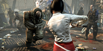 A female character threatens a large zombie with a sword