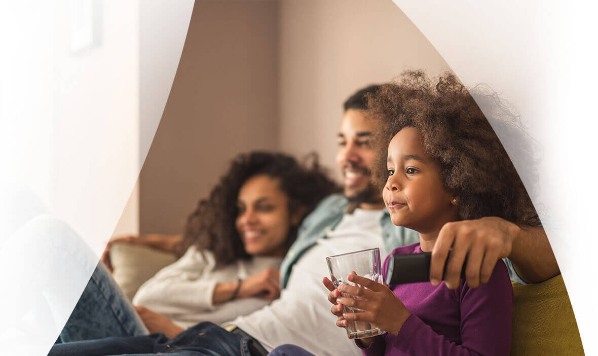 Family sat together watching TV.