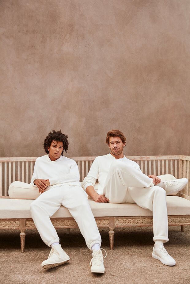 Two men on a low bench wearing david gandy wellwear white sweat sets