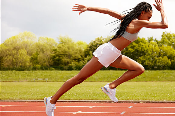 woman sprinting on running track