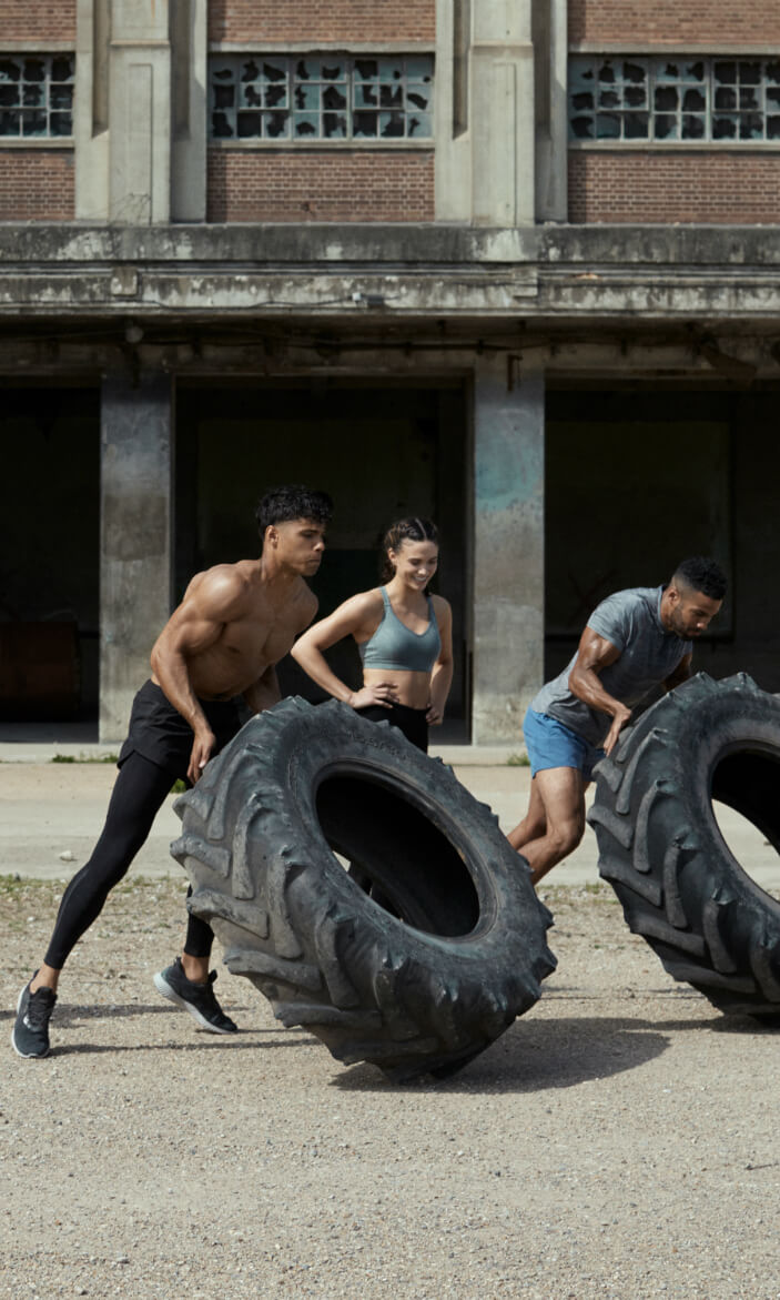 Men pushing tyre